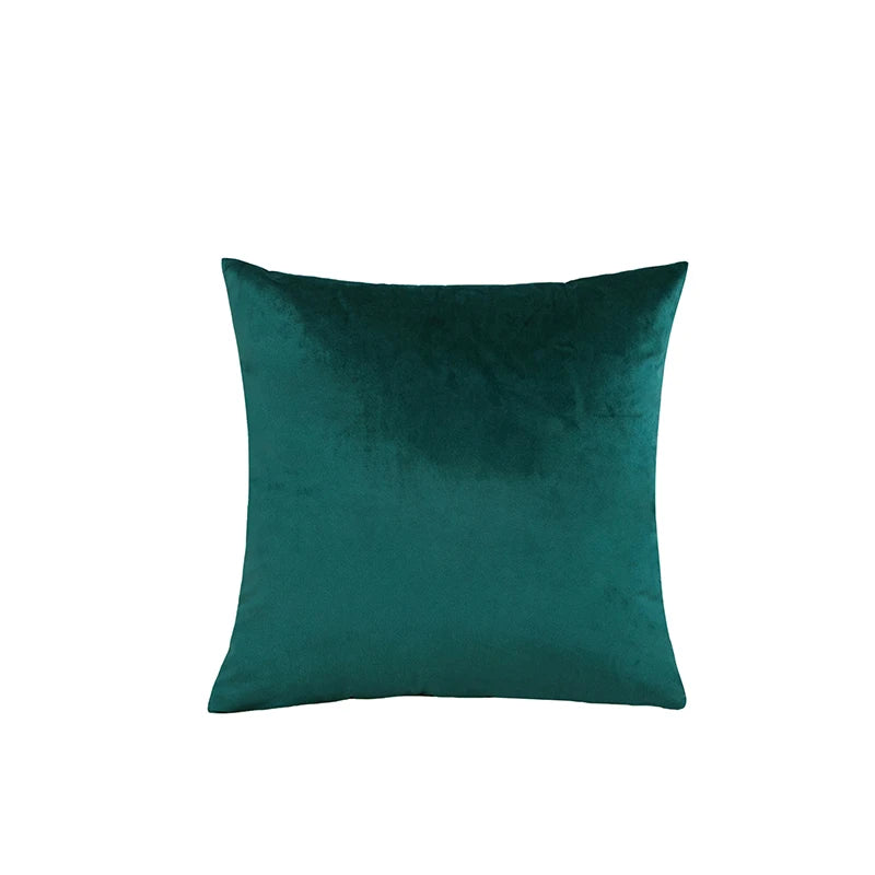 Green velvet pillow on a white background