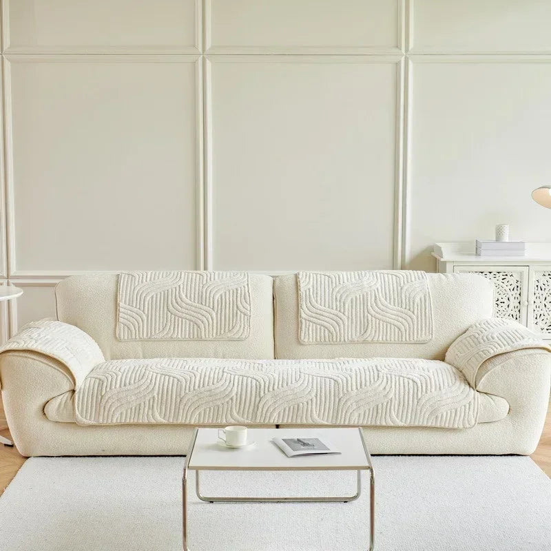 Beige sofa cover with wave pattern in a minimalistic living room.