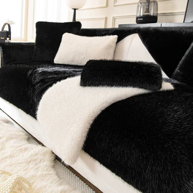 Black and white fur throw blanket on a sofa in a living room setting.