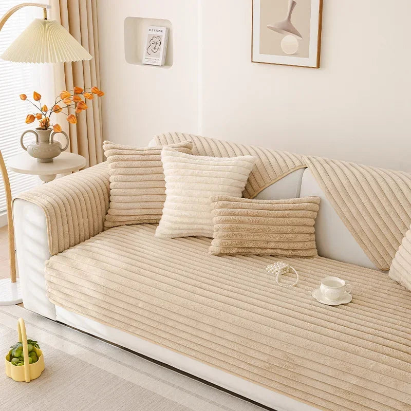 Plush beige textured sofa cover on a couch with decorative pillows in a living room setting.