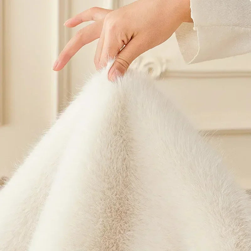 Close-up of a hand touching white fluffy fabric