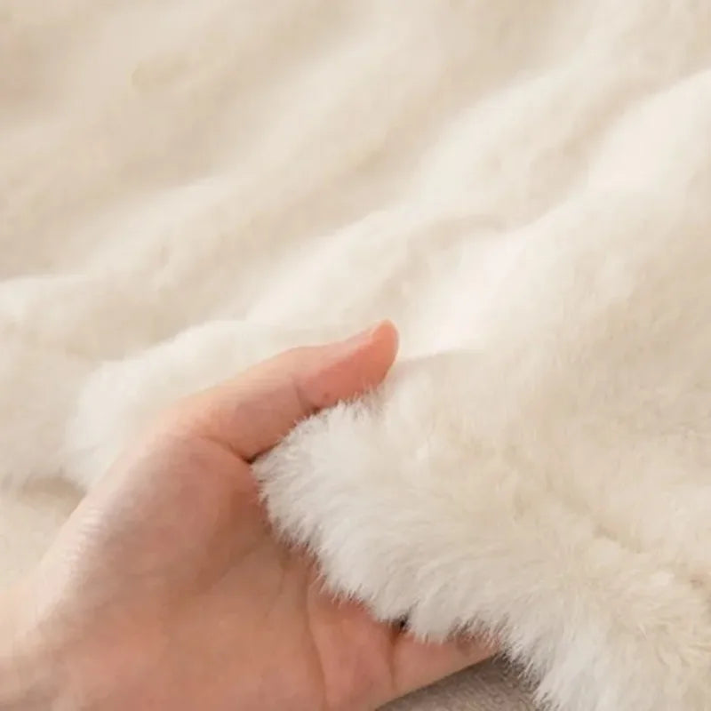 Close-up of a hand holding a fluffy white paw