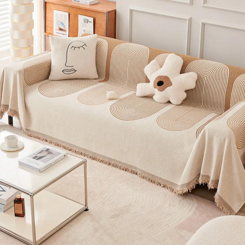 Beige sofa with decorative pillows and a coffee table in a living room setting.