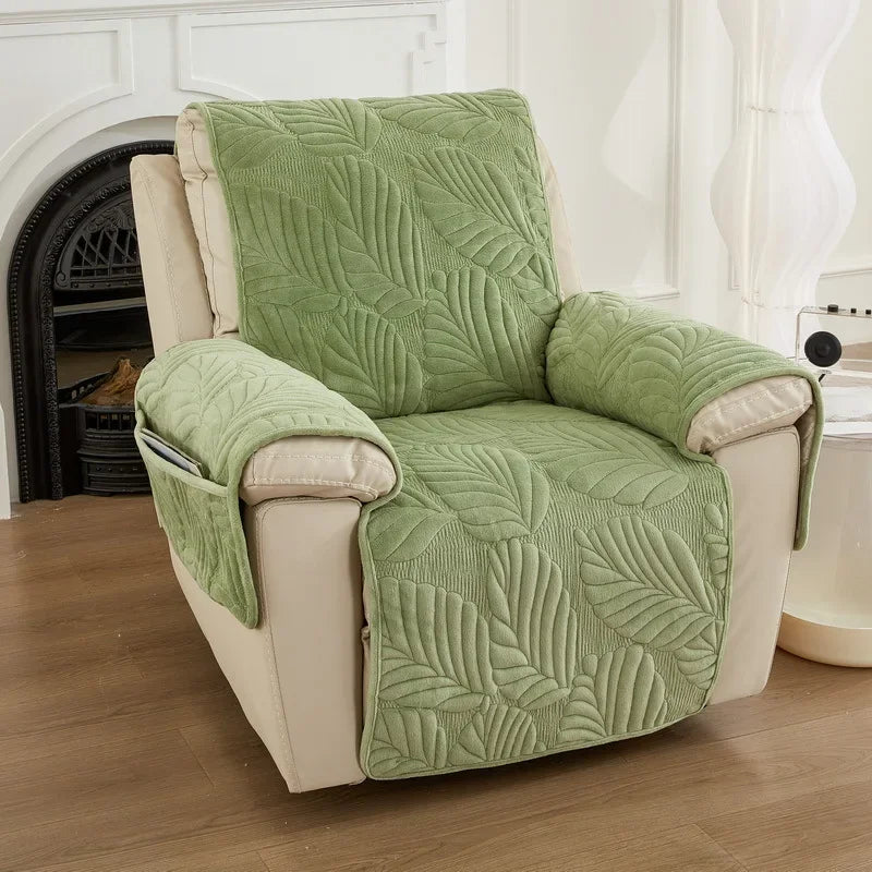 Green leaf-patterned recliner cover on a beige recliner chair in a home setting.