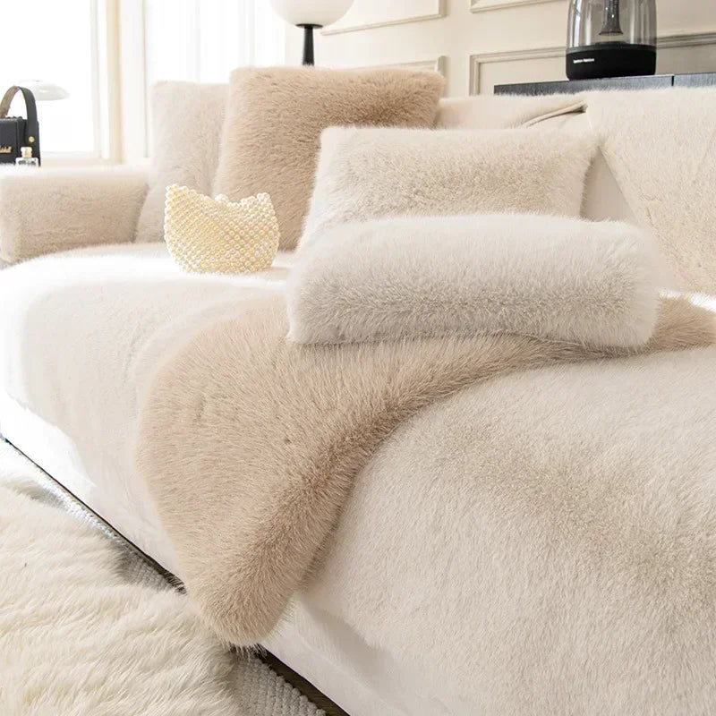 Beige fluffy bedding set on a bed with pillows and a blanket.
