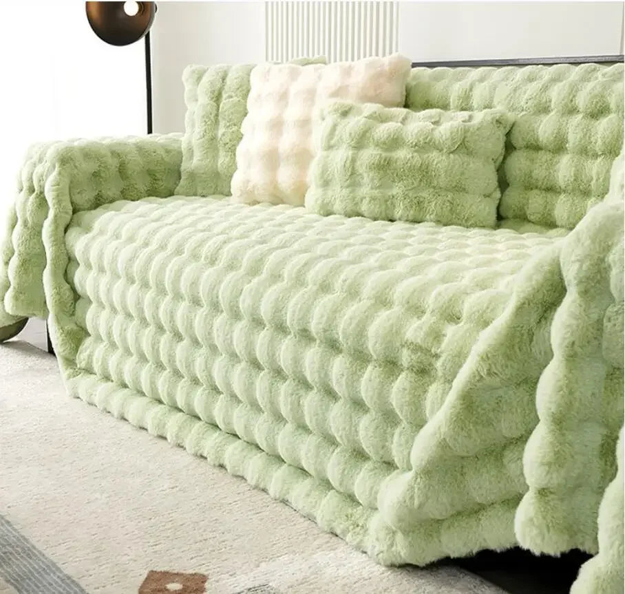 Mint green plush faux rabbit bubble sofa cover on a couch in a living room setting