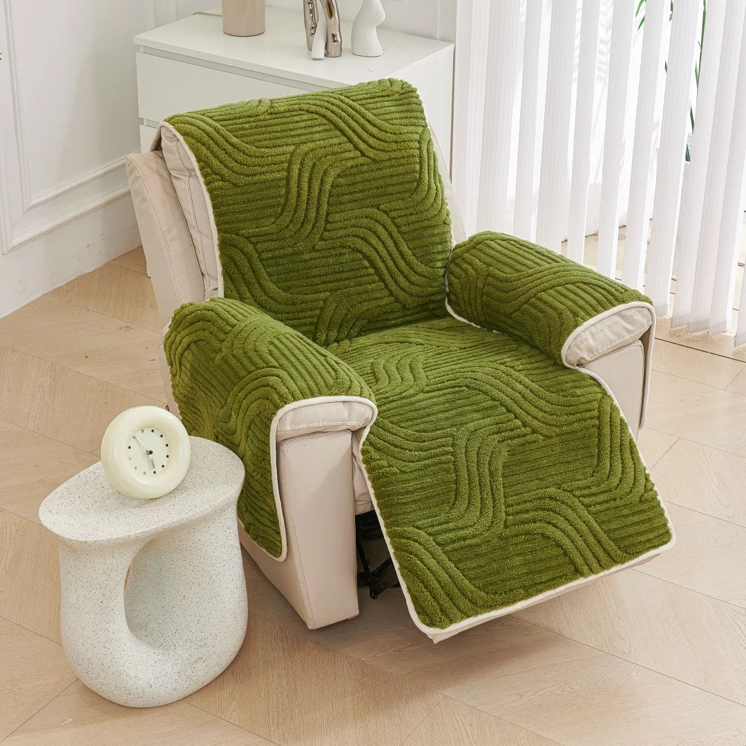 Green textured armchair cover on a beige armchair in a room with a white side table.