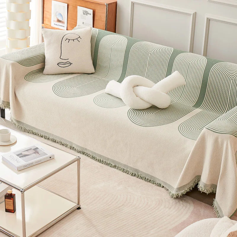 Sofa with a green and beige patterned cover in a living room setting.