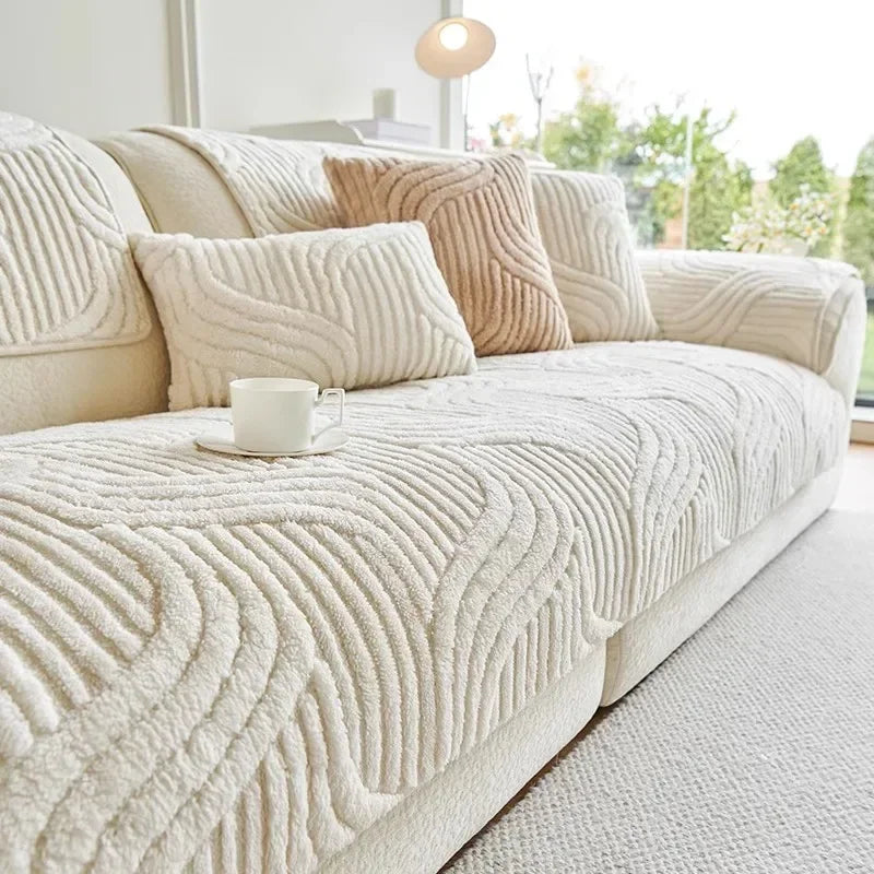Beige wave textured sofa cover with decorative pillows in a bright living room.
