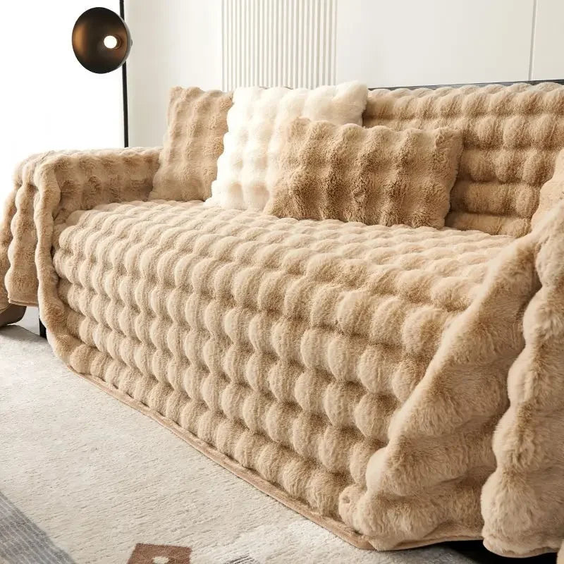 Beige plush faux rabbit bubble sofa with matching throw blanket in a living room setting