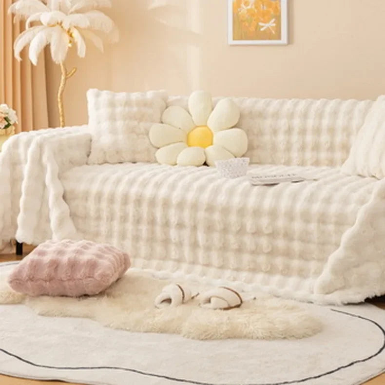 White plush faux rabbit bubble sofa with decorative pillows in a cozy living room setting.