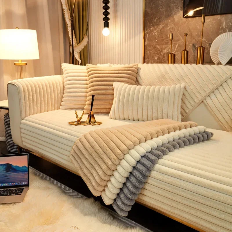 Beige, white and grey textured blanket draped over a sofa in a stylish living room.