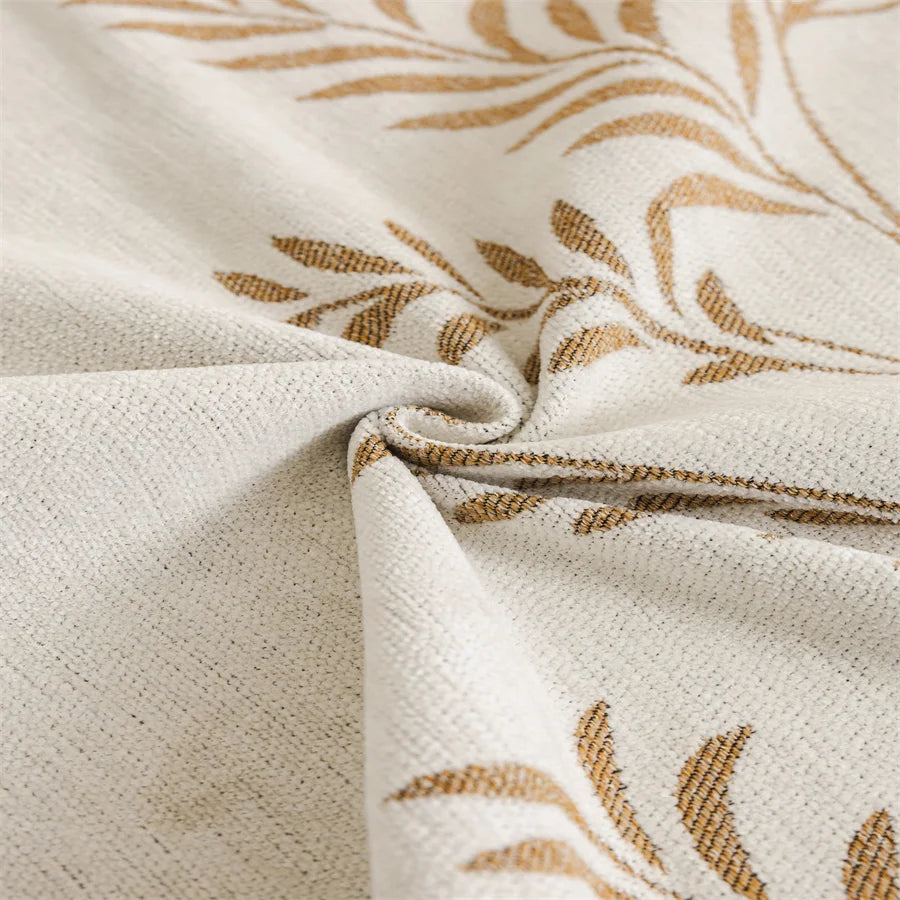 Close-up of beige fabric with subtle leaf pattern