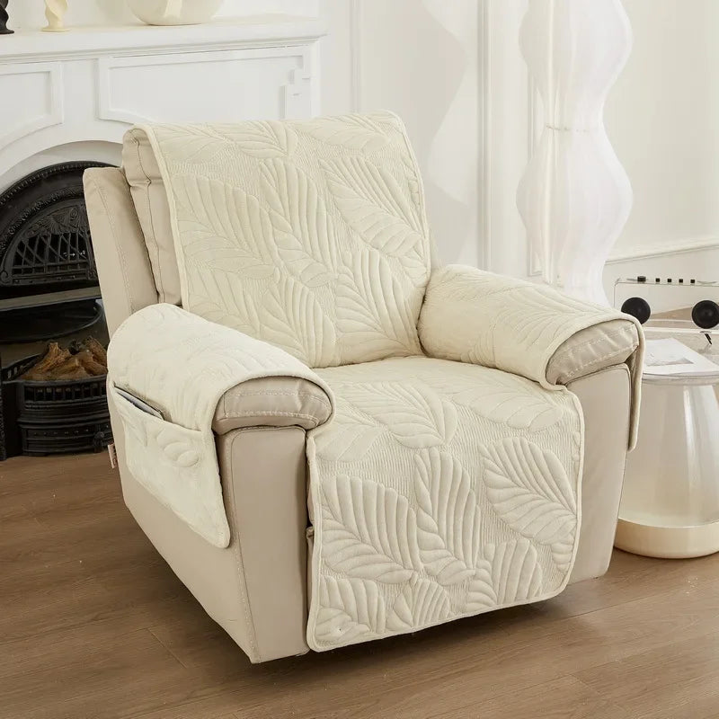 Beige recliner chair cover with patterned cover in a room with a fireplace and curtains.