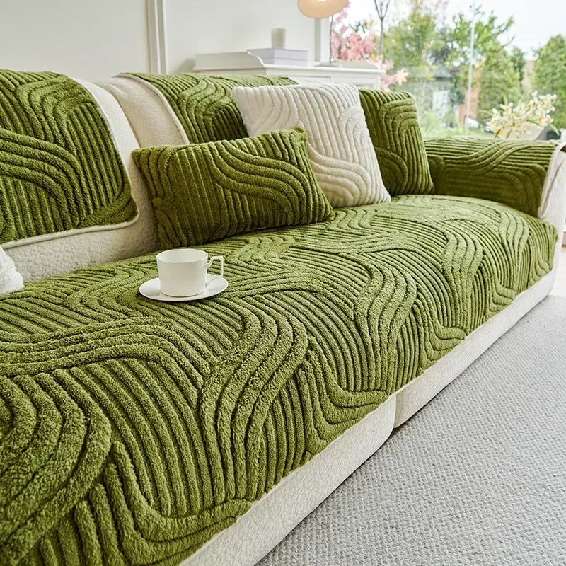Green wave textured sofa cover on a sofa with a cup and saucer on a table.