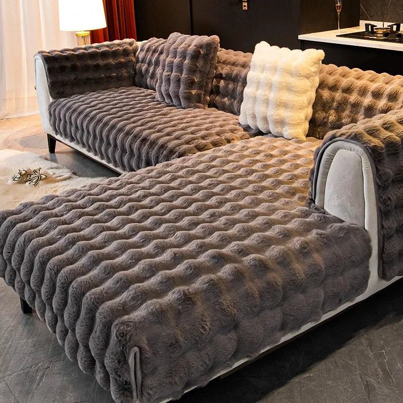 Grey textured plush soft sofa with decorative pillows in a living room setting