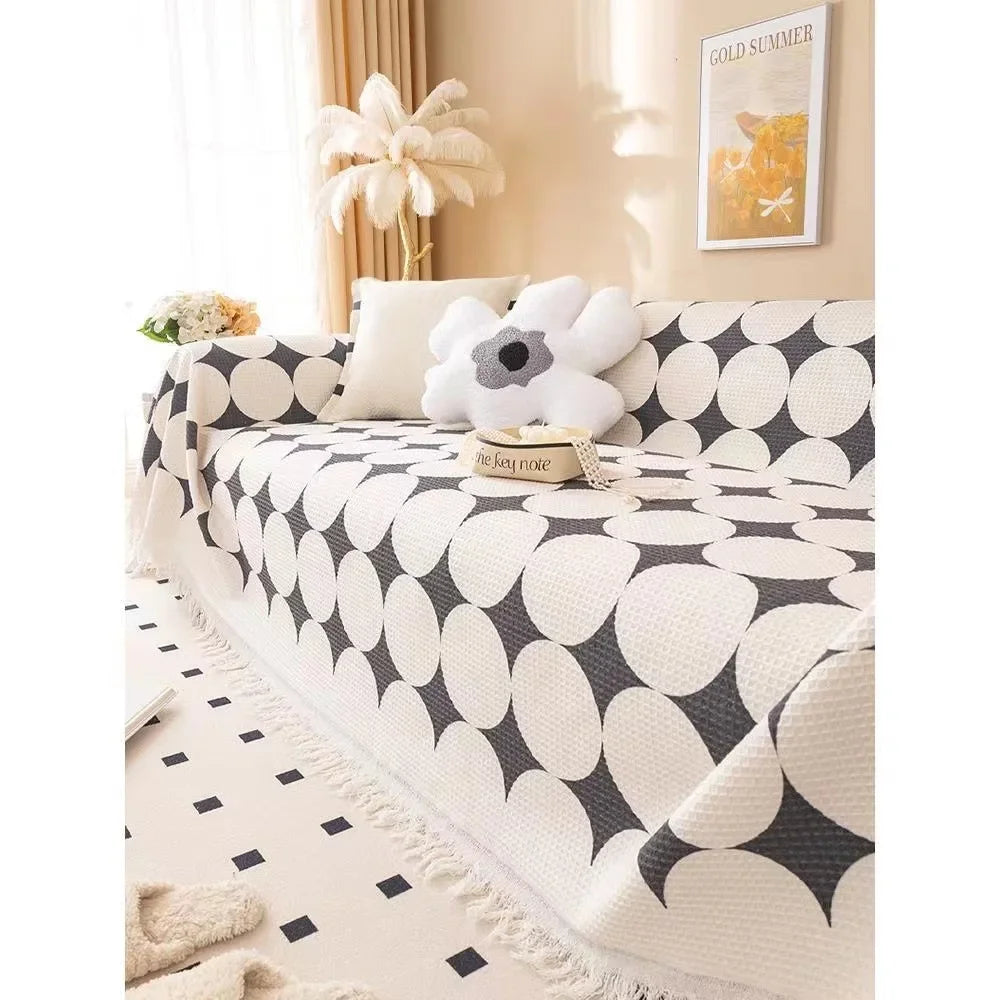 Sofa with a patterned cover and decorative pillows in a living room setting.