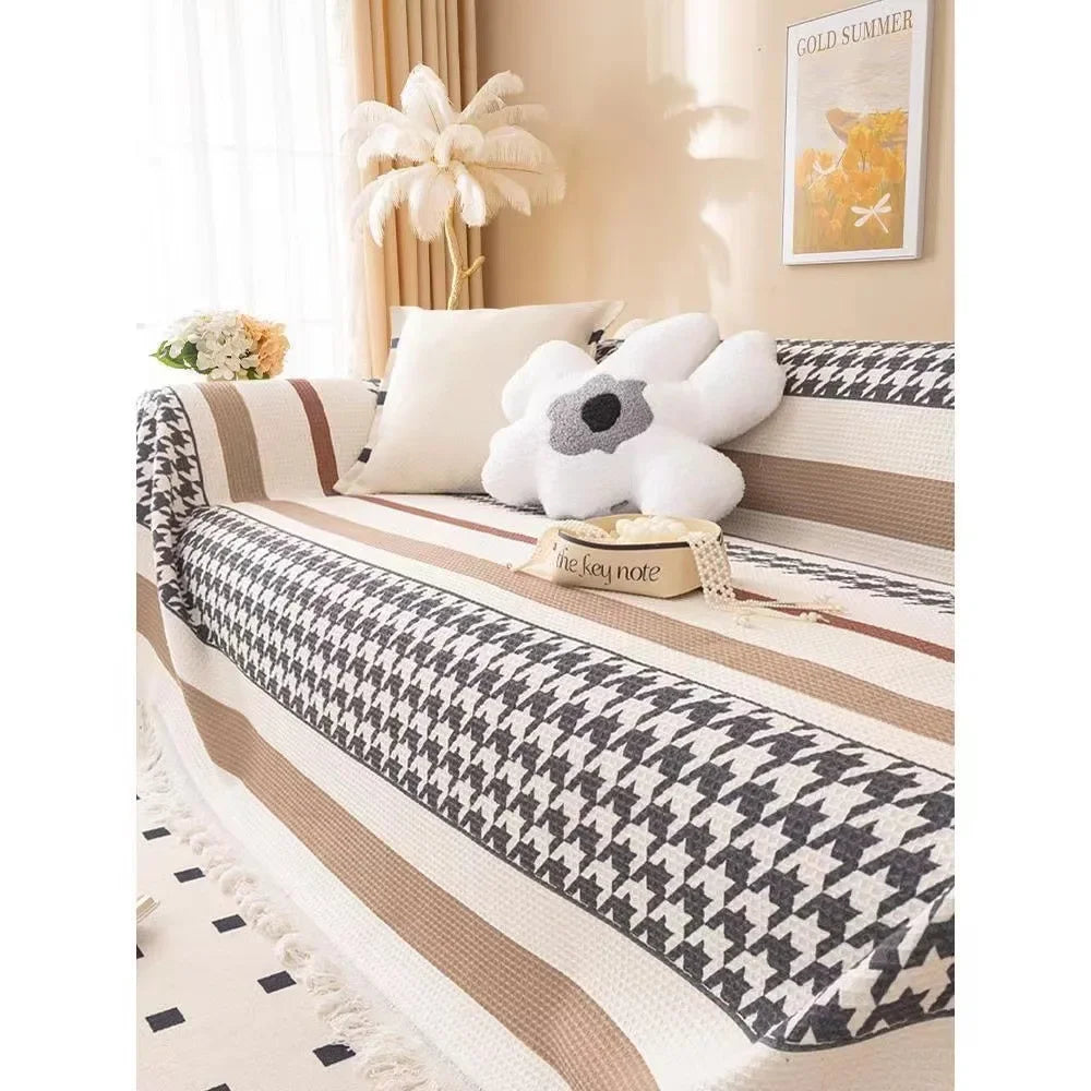Sofa with a houndstooth patterned cover in a living room setting.