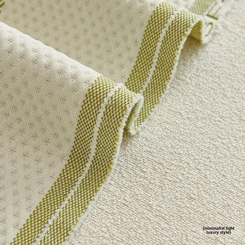 Close-up of textured fabric with green stripes on a beige background