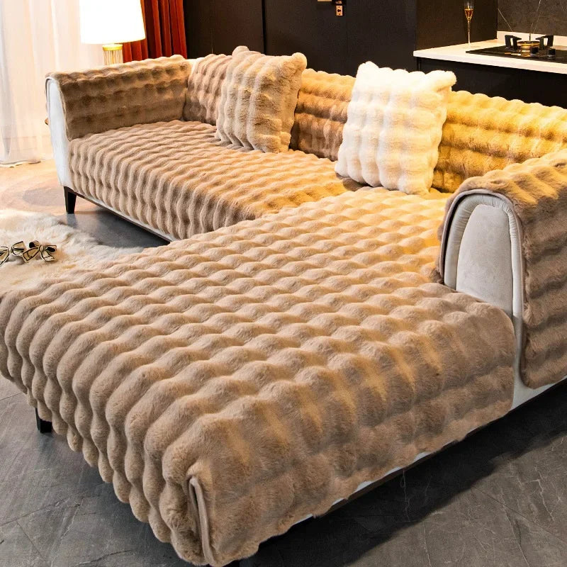 Brown textured plush soft sofa with decorative pillows in a living room setting.