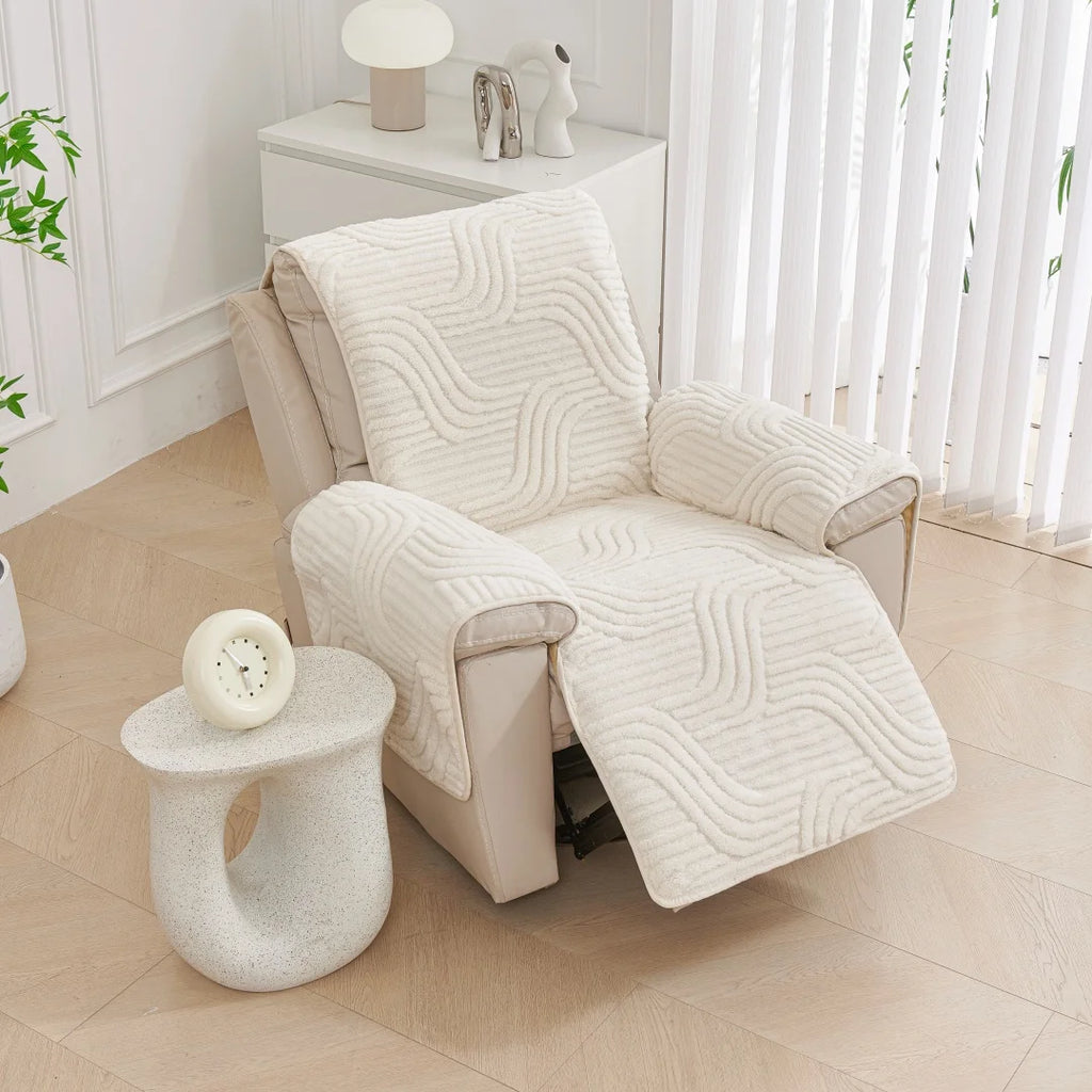White armchair with a textured cover in a bright room with a small table and plant.