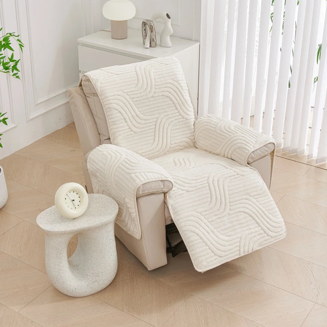 White armchair with a textured cover in a bright room with a small table and plant.