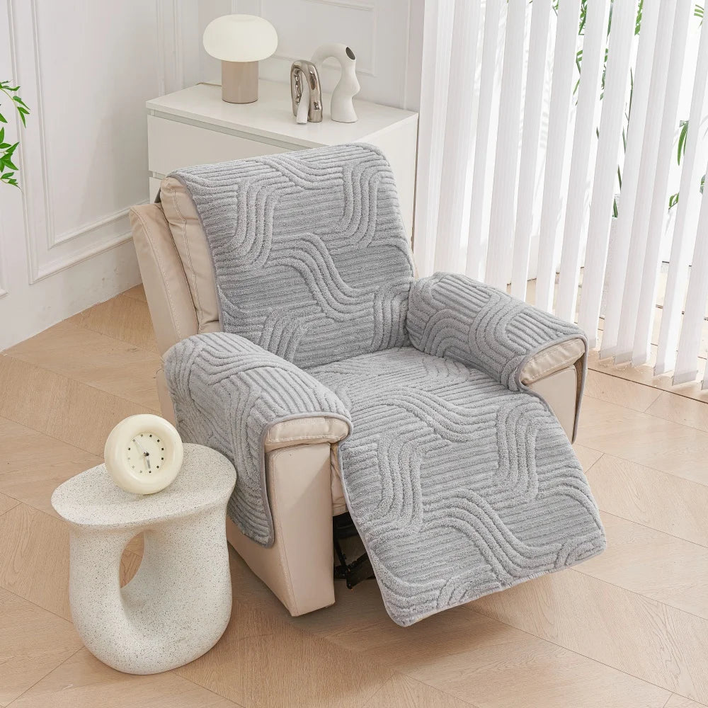 Chair with a gray textured cover in a room with a side table and lamp.
