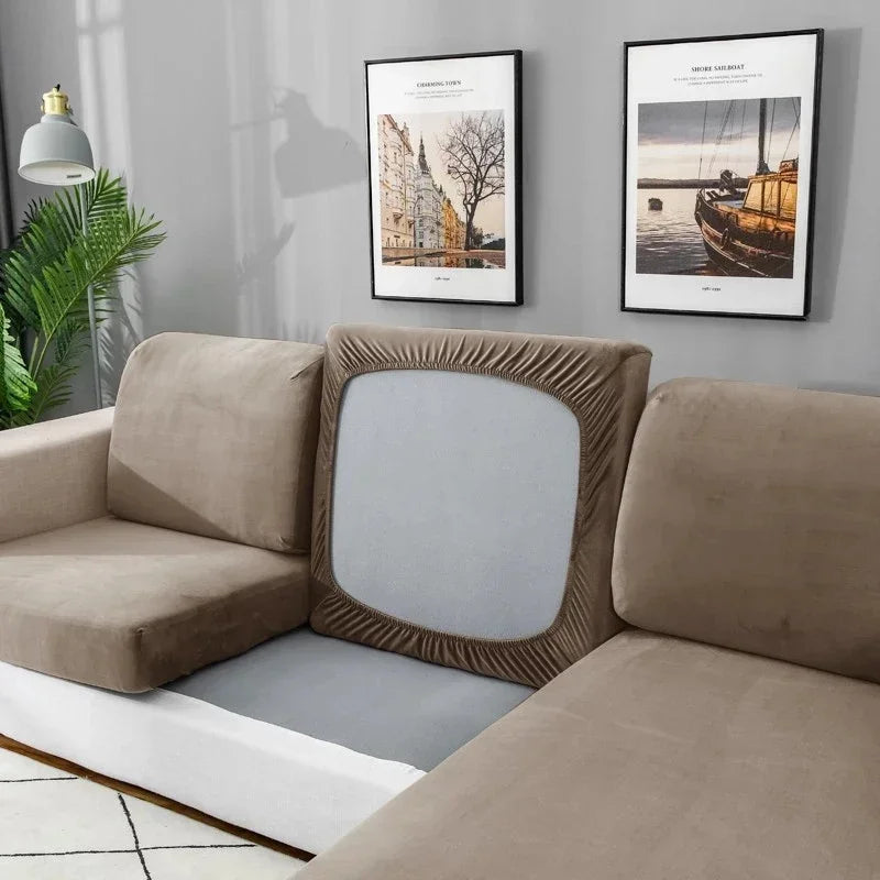 Beige sectional sofa with a decorative pillow in a living room setting.